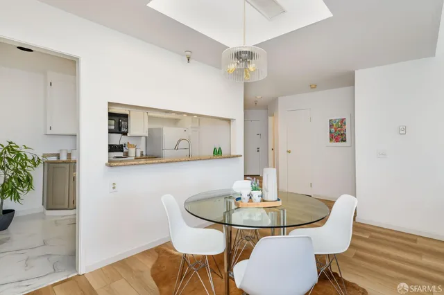 a view of a dining room with furniture and wooden floor
