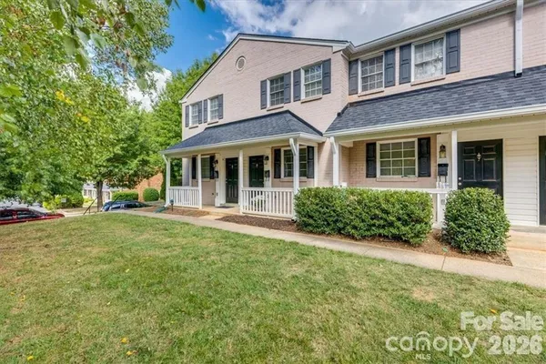 front view of a brick house with a yard