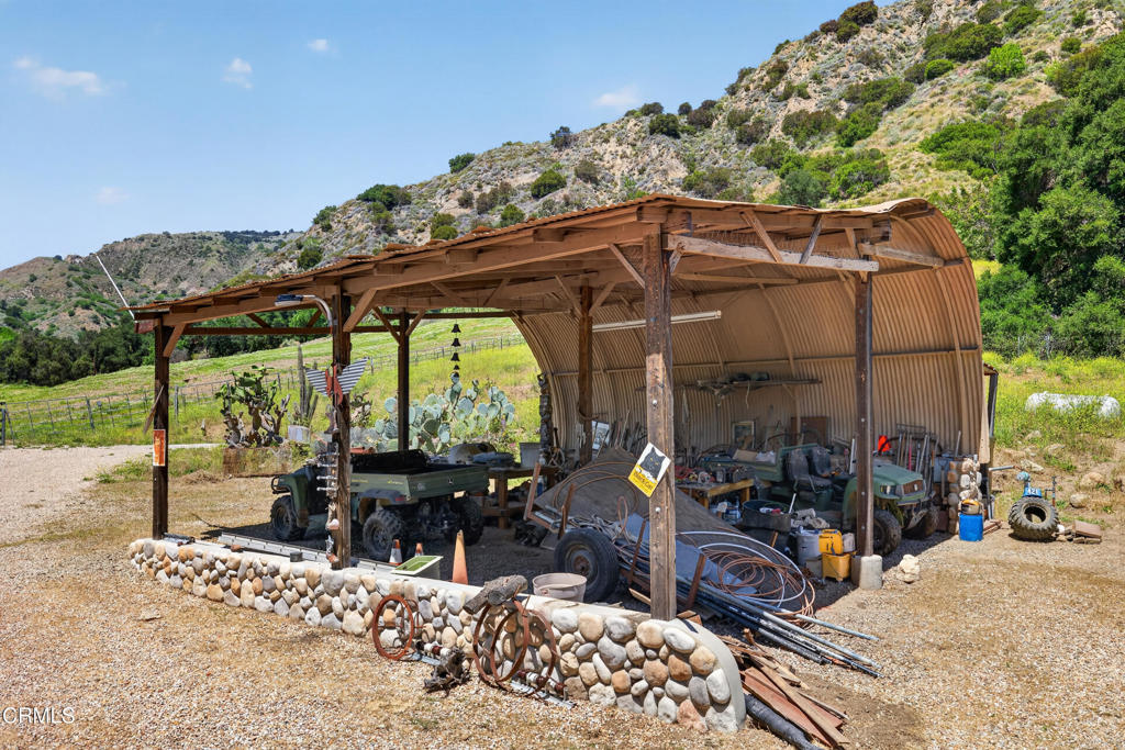 8416 Wheeler Canyon Road Santa Paula, CA 93060 - Photo 27 of 48 a view of a patio with table and chairs under an umbrella