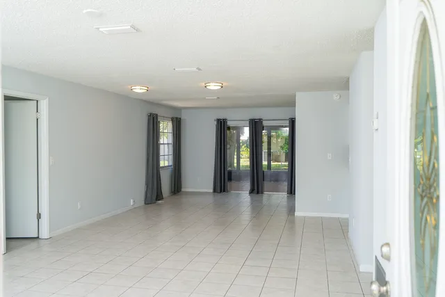 a view of an empty room with glass door