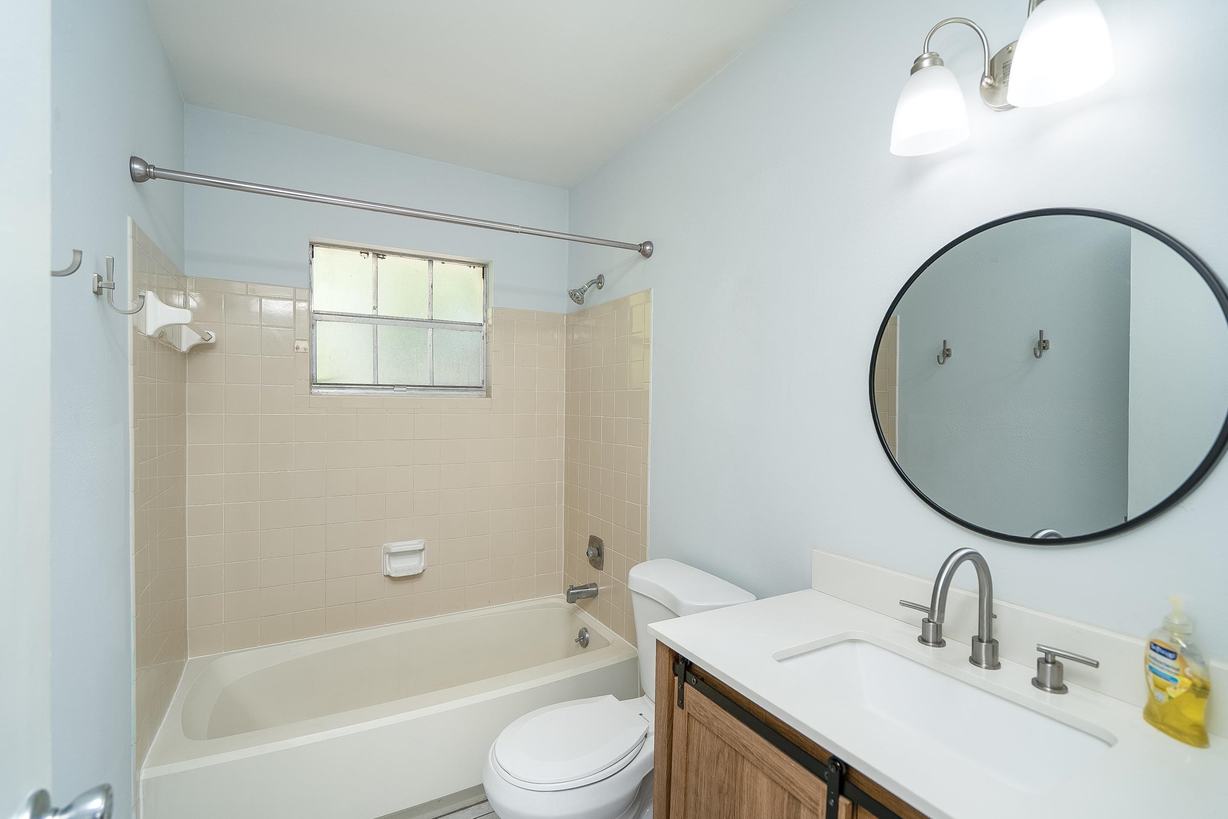 354 Shores Boulevard St. Augustine, FL 32086 - Photo 22 of 34 a bathroom with a sink a toilet and a mirror