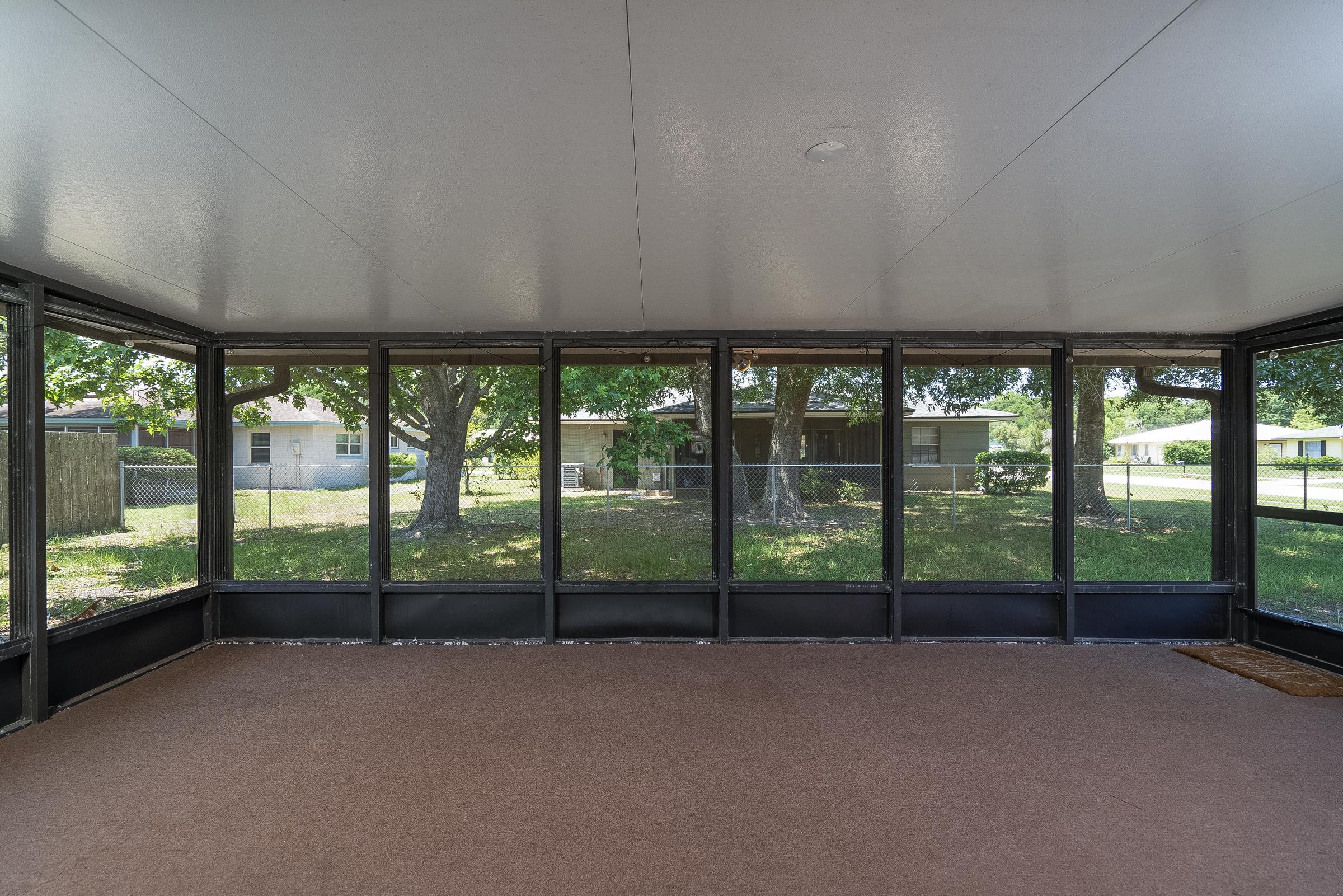 354 Shores Boulevard St. Augustine, FL 32086 - Photo 24 of 34 a view of a big room with large windows and city view