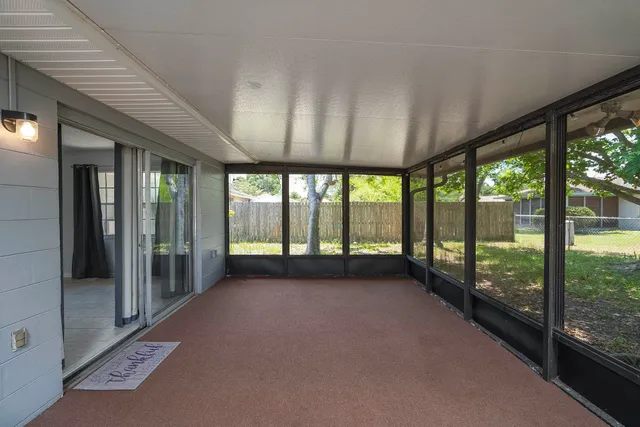a view of an empty room with windows and a balcony