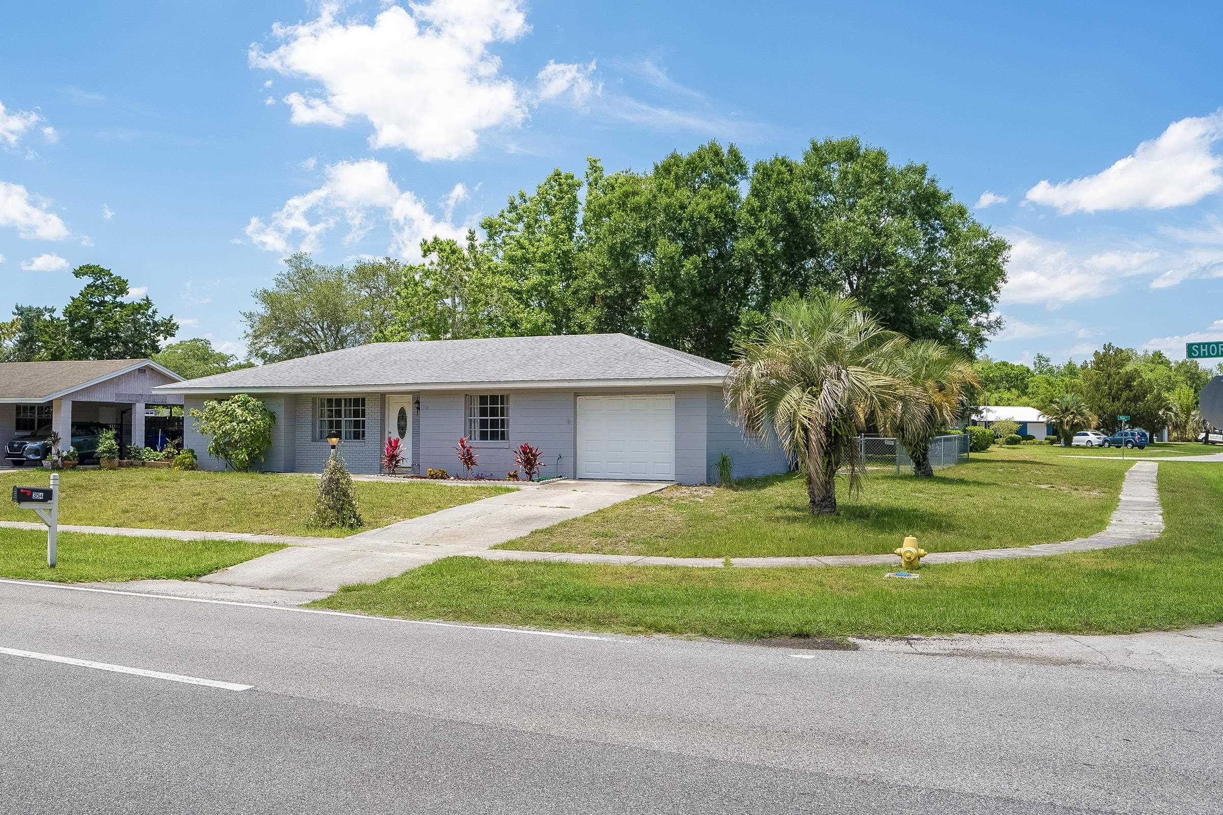 354 Shores Boulevard St. Augustine, FL 32086 - Photo 3 of 34 a front view of a house with a yard and trees