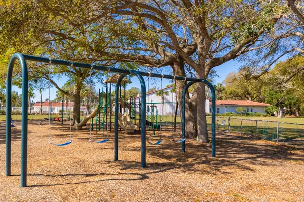 a view of a park with iron fence
