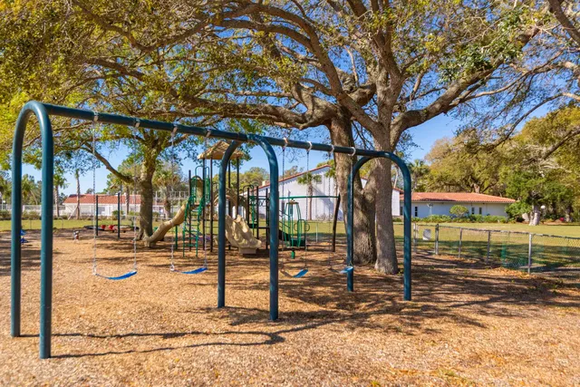 a view of a park with iron fence