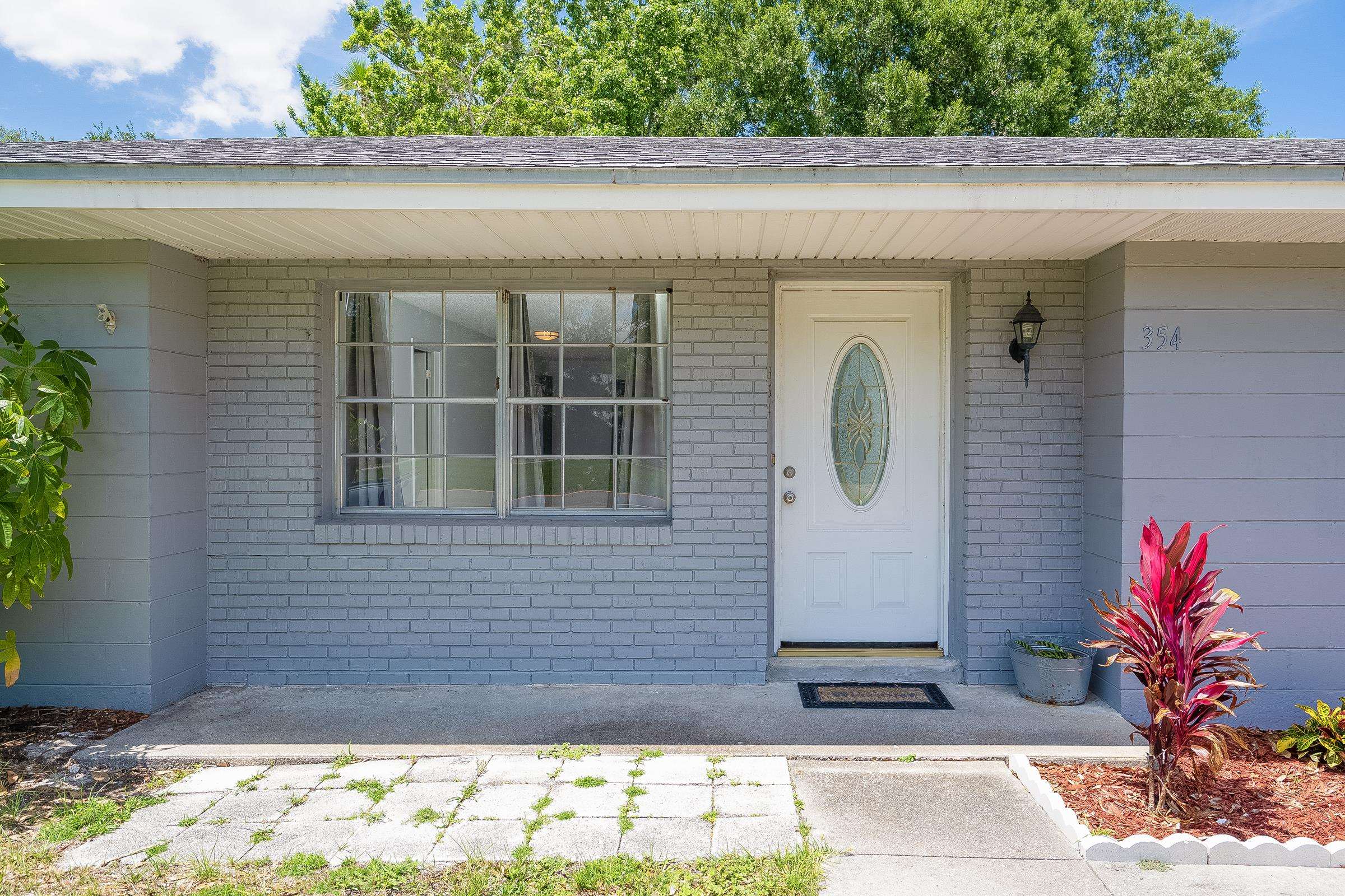354 Shores Boulevard St. Augustine, FL 32086 - Photo 6 of 34 a front view of a house with a yard