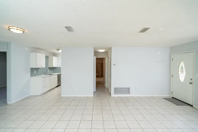 a view of a kitchen with white cabinets