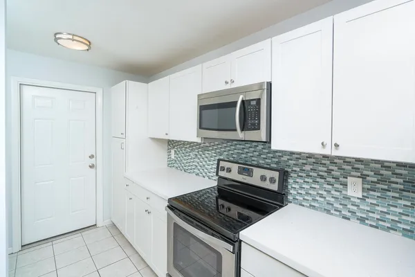 a kitchen with a stove and a microwave