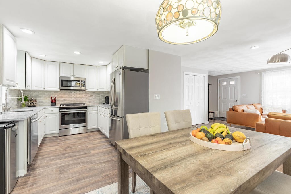 3 Elginwood Road, Unit B Peabody, MA 01960 - Photo 12 of 30 a living room with furniture a fireplace and a table