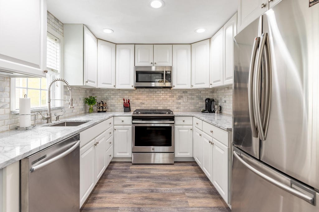 3 Elginwood Road, Unit B Peabody, MA 01960 - Photo 14 of 30 a kitchen with white cabinets stainless steel appliances and a sink