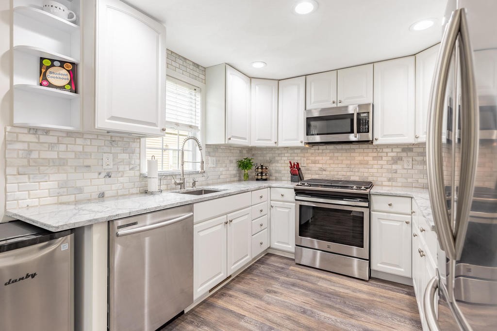 3 Elginwood Road, Unit B Peabody, MA 01960 - Photo 15 of 30 a kitchen with stainless steel appliances granite countertop a stove a sink and a microwave