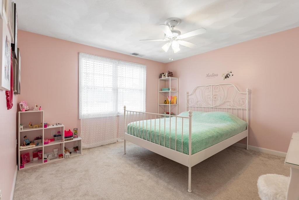 3 Elginwood Road, Unit B Peabody, MA 01960 - Photo 19 of 30 a bedroom with a bed and a chandelier