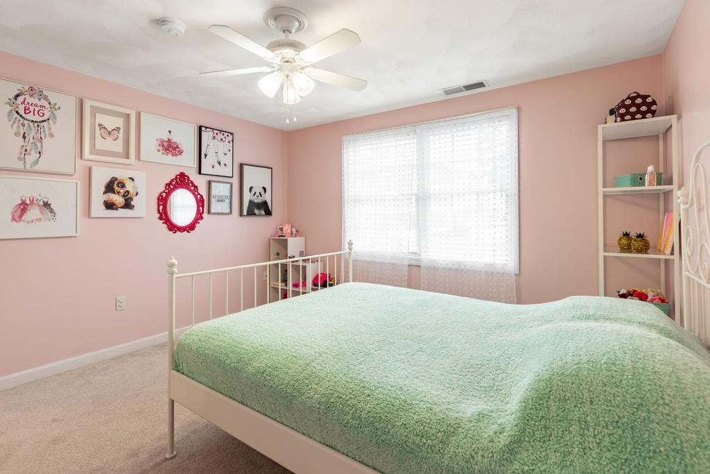 3 Elginwood Road, Unit B Peabody, MA 01960 - Photo 20 of 30 a bedroom with a bed and a chandelier