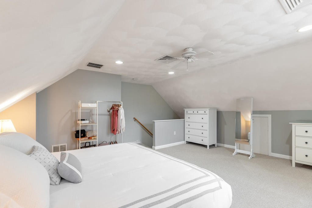 3 Elginwood Road, Unit B Peabody, MA 01960 - Photo 24 of 30 a bed room with a bed and a chandelier