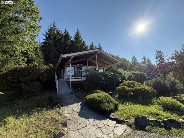 a view of house with backyard and outdoor seating