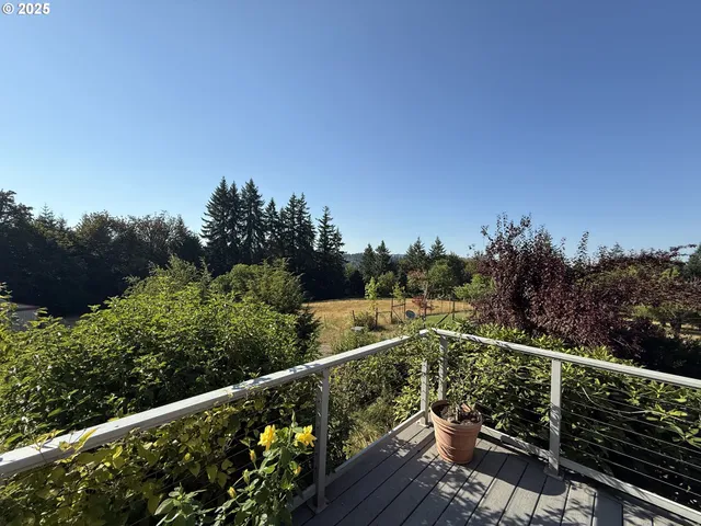 a view of a balcony with wooden fence