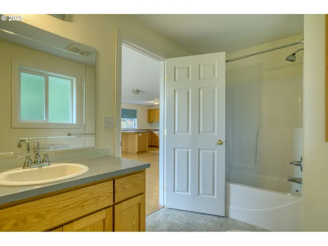 a bathroom with a sink a mirror and a shower