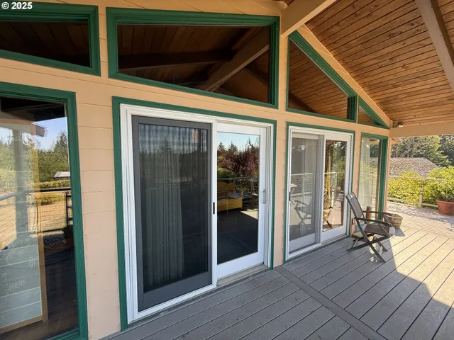 a view of a porch with wooden floor and furniture