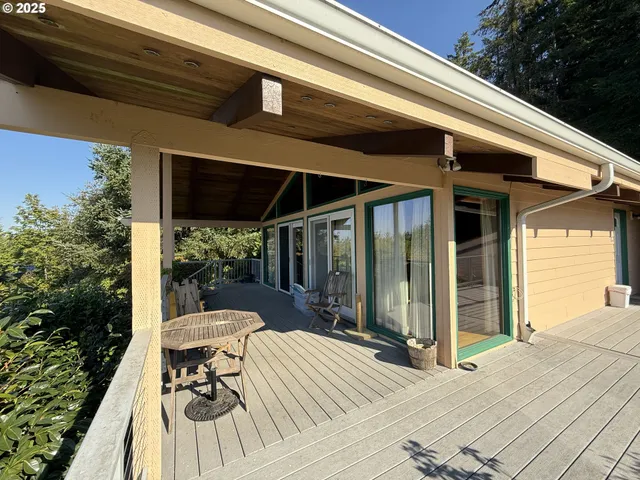 a view of balcony with wooden floor and seating space
