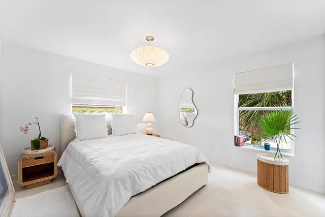 a bedroom with a bed and a potted plant