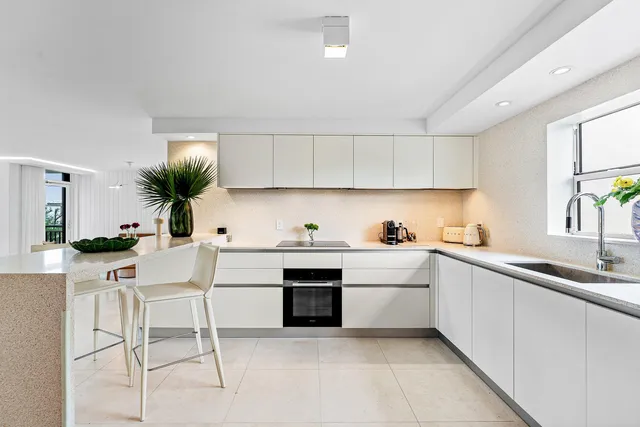 a kitchen with a sink cabinets and window