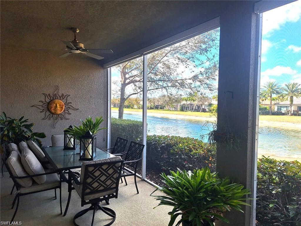 2335 Sawyers Hill Road, Unit 503 Naples, FL 34120 - Photo 14 of 23 a table and chairs in front of a room with wooden floor