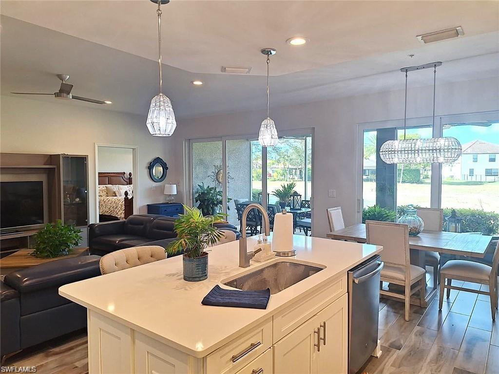 2335 Sawyers Hill Road, Unit 503 Naples, FL 34120 - Photo 2 of 23 a kitchen with a table a sink and cabinets