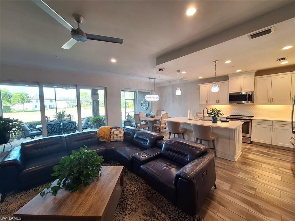 2335 Sawyers Hill Road, Unit 503 Naples, FL 34120 - Photo 5 of 23 a living room with furniture kitchen and a large window