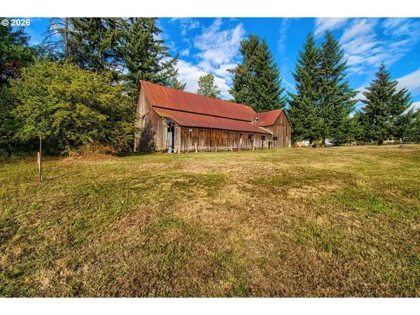 a backyard of a house with table and chairs