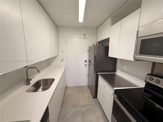 a kitchen with refrigerator and stove