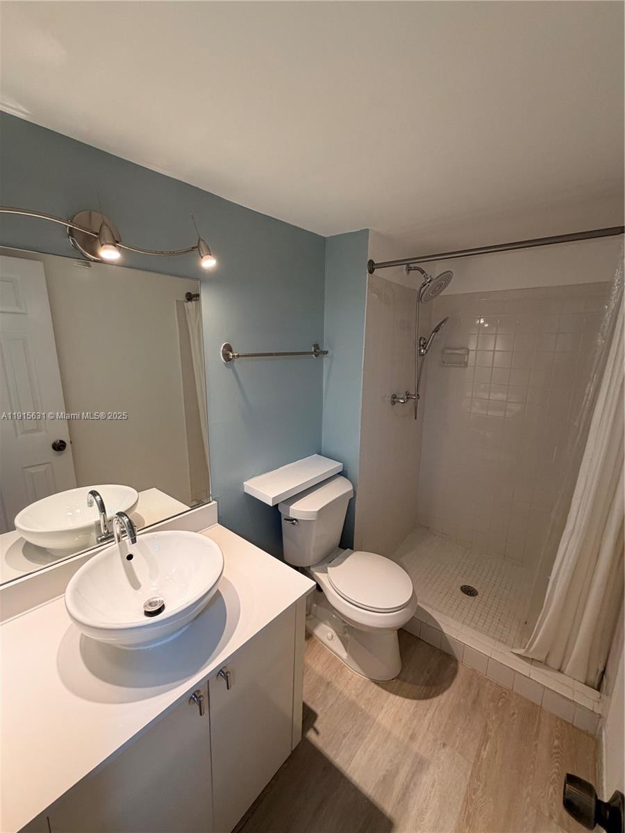 2350 Northeast 135th Street, Unit 503 North Miami, FL 33181 - Photo 5 of 9 a bathroom with a sink toilet and shower