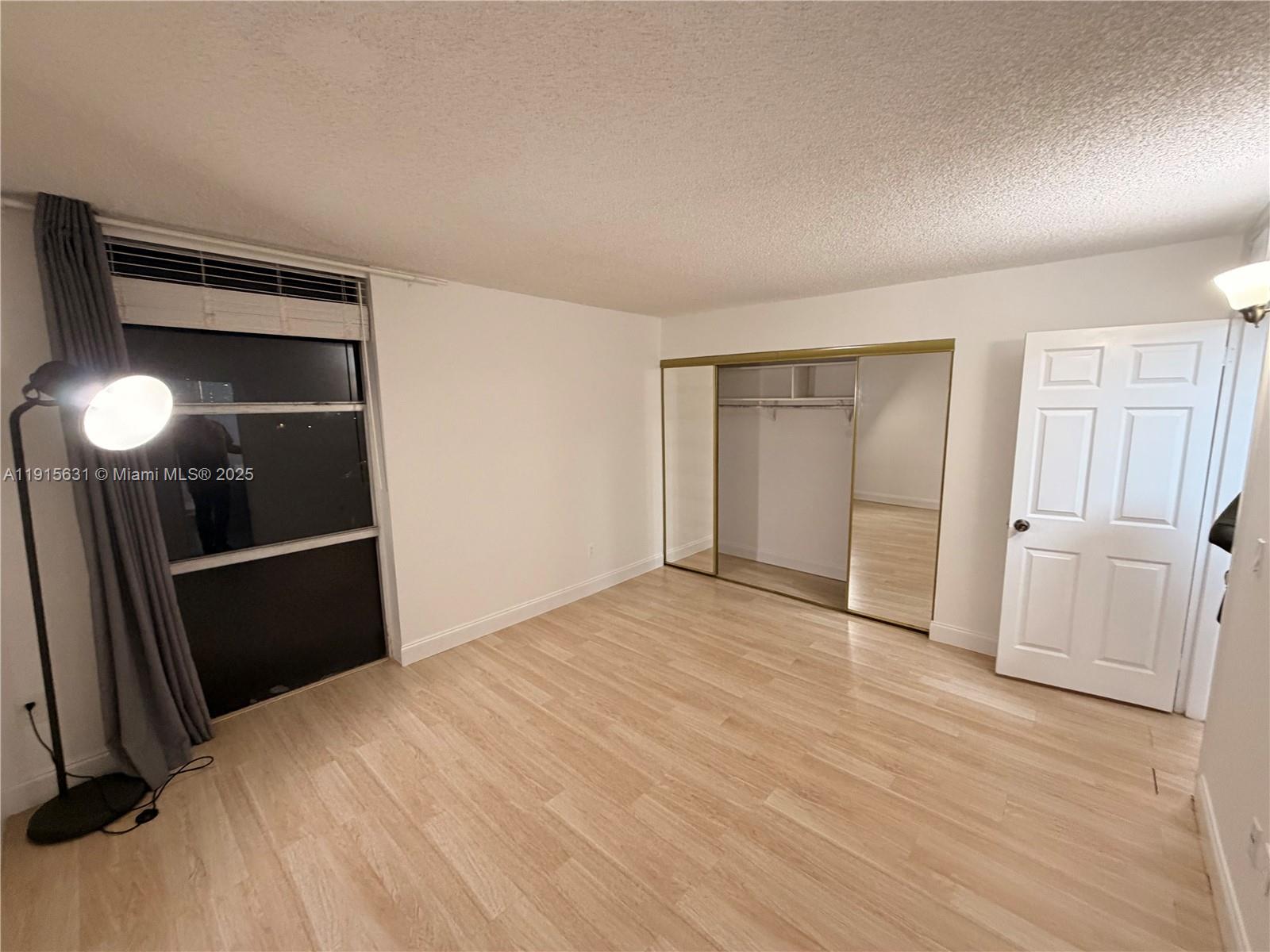 2350 Northeast 135th Street, Unit 503 North Miami, FL 33181 - Photo 9 of 9 a view of empty room with wooden floor