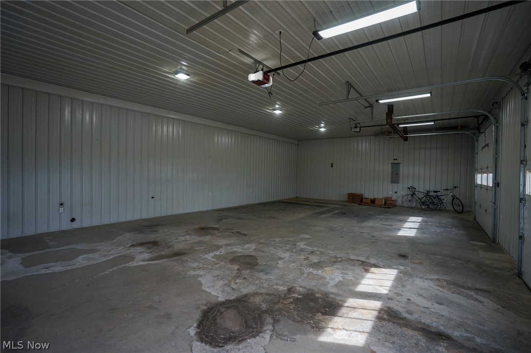 1325 County Line Road Hopewell, OH 43746 - Photo 28 of 45 Garage featuring metal wall, a garage door opener, and electric panel