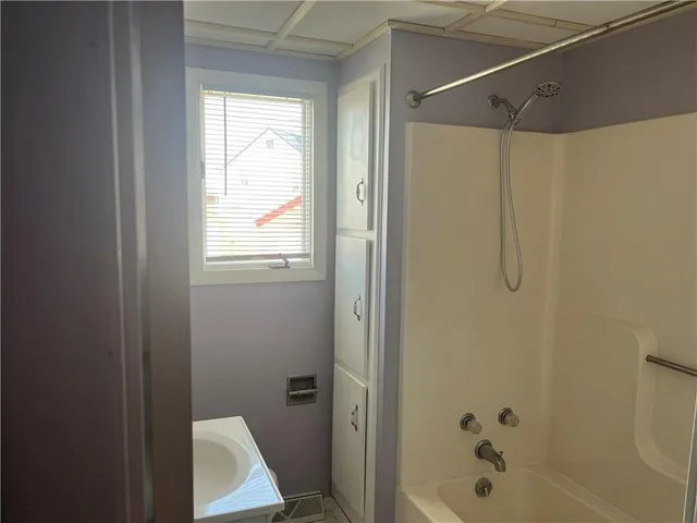 a bathroom with a bathtub and shower