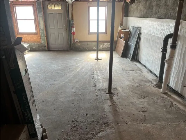 a view of an empty room with brick wall and a window