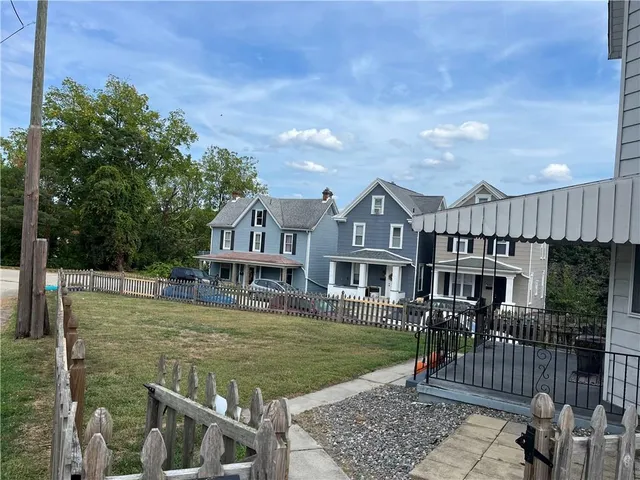 a view of a house with backyard porch and sitting area