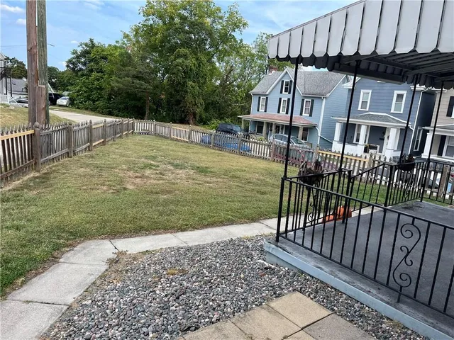 a view of a house with backyard and porch