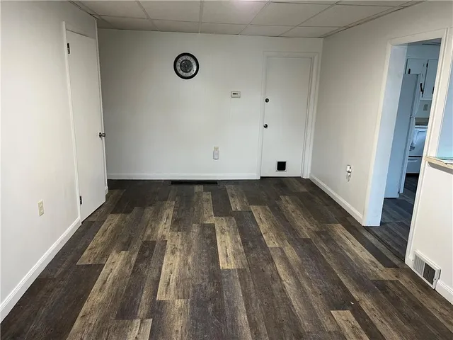 a view of a room with wooden floor