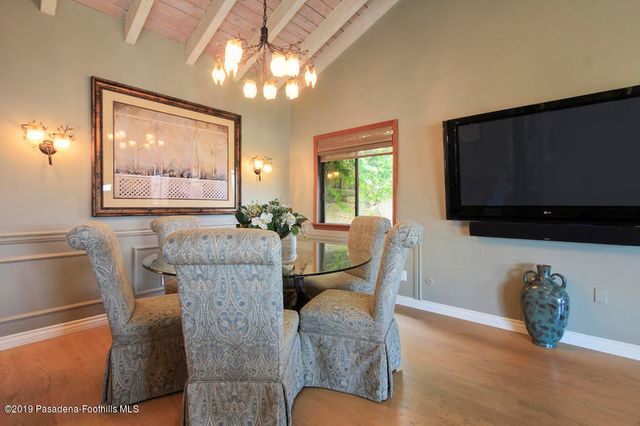 a living room with furniture a flat screen tv and a large window