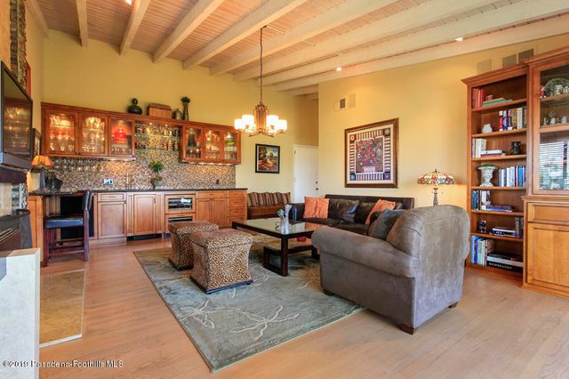 a living room with furniture and kitchen view