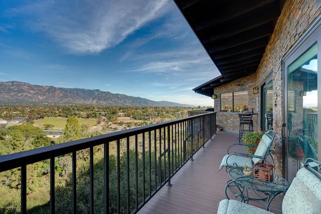a view of a balcony with chair and wooden floor