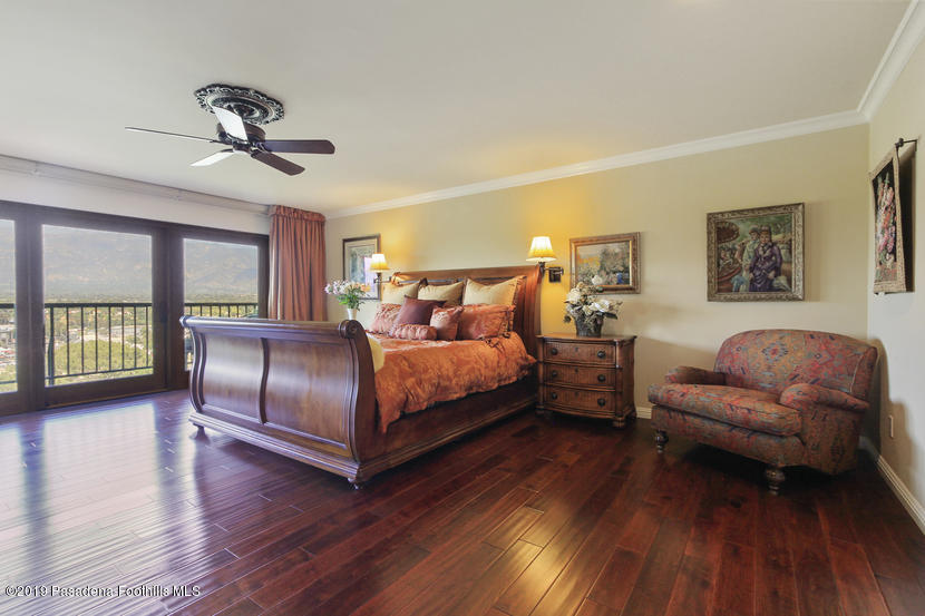 943 Glen Oaks Boulevard Pasadena, CA 91105 - Photo 19 of 38 a bedroom with a bed couch and a large window