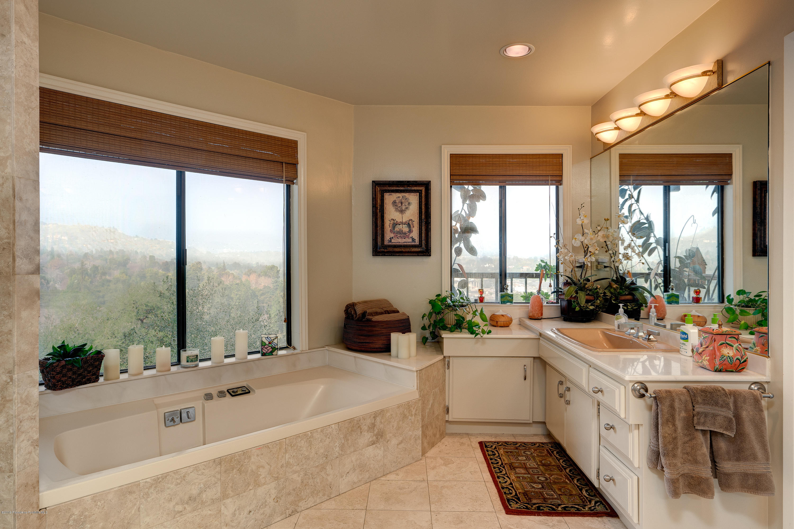 943 Glen Oaks Boulevard Pasadena, CA 91105 - Photo 22 of 38 a large white bathroom with a large tub and sink