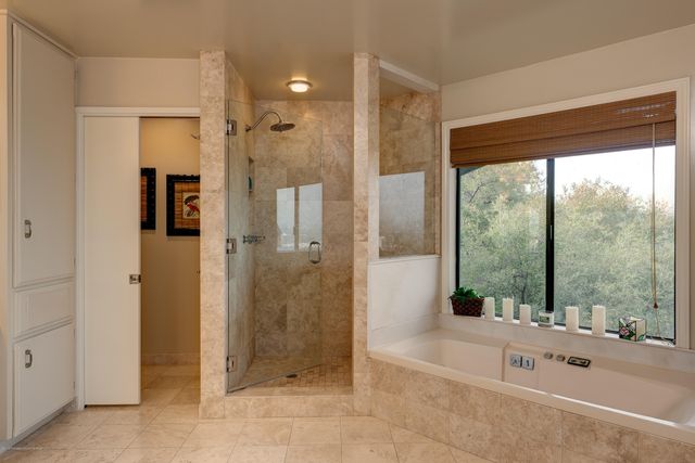 a bathroom with a tub shower and sink
