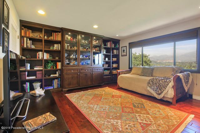 a living room with lots of furniture and a book shelf