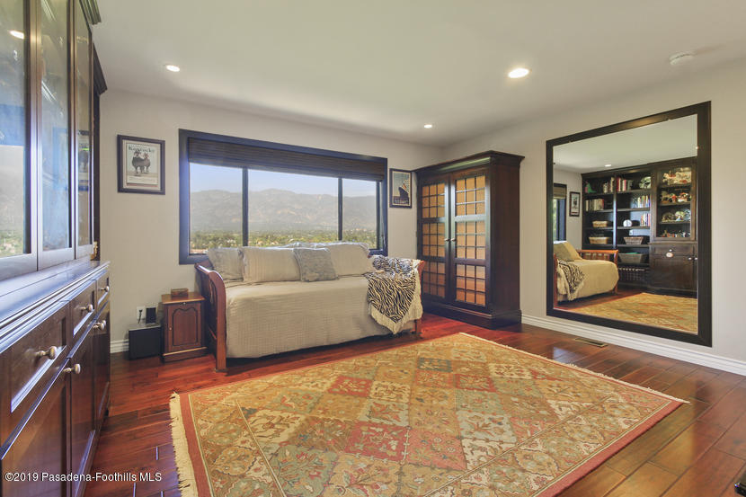 943 Glen Oaks Boulevard Pasadena, CA 91105 - Photo 25 of 38 a living room with furniture and a flat screen tv