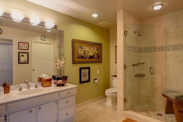 a spacious bathroom with a granite countertop sink toilet and shower