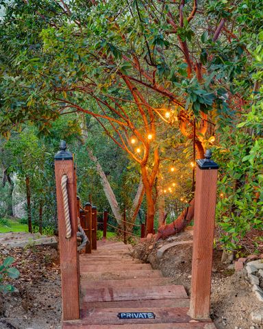 a wooden fence with large trees