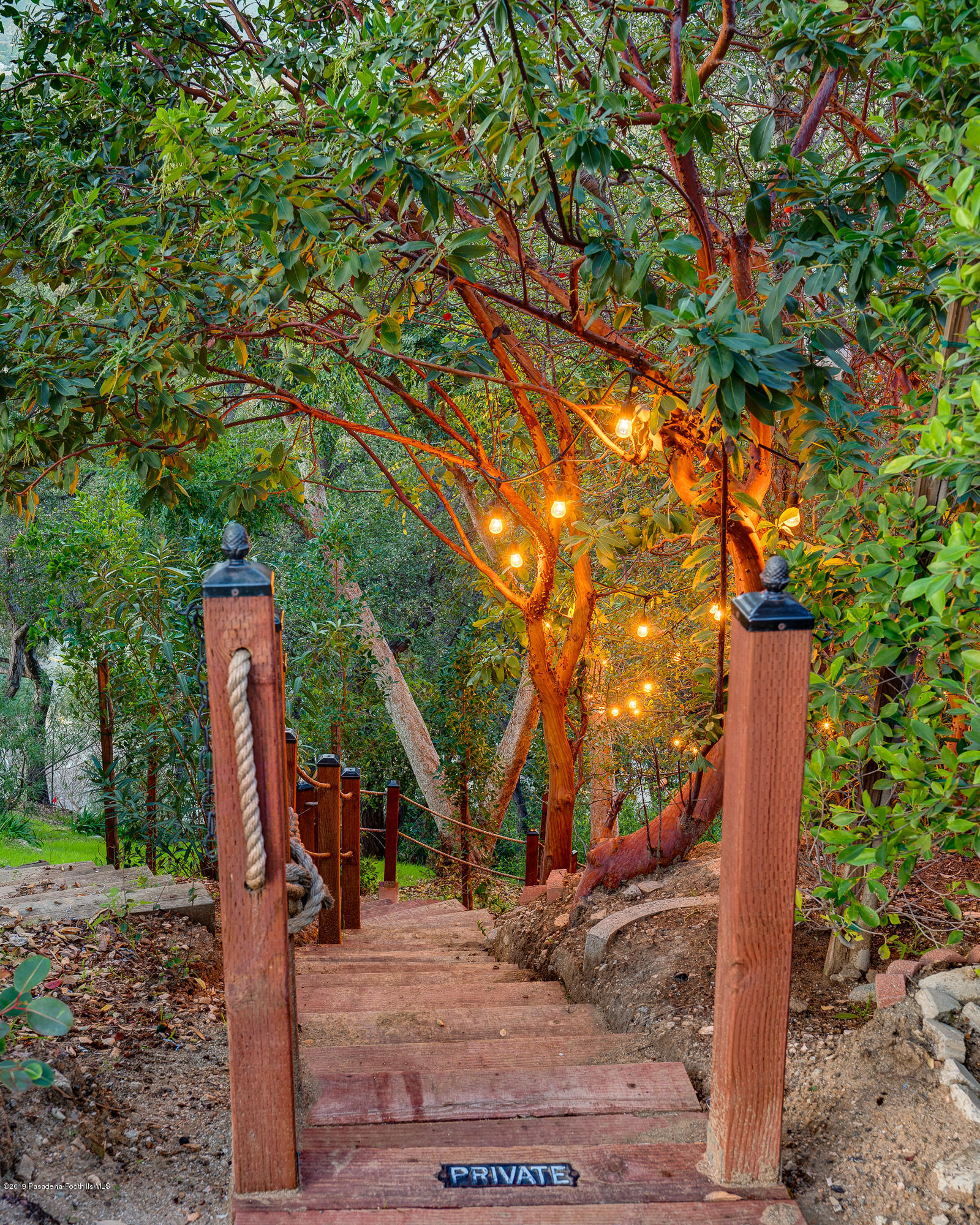 943 Glen Oaks Boulevard Pasadena, CA 91105 - Photo 32 of 38 a wooden fence with large trees